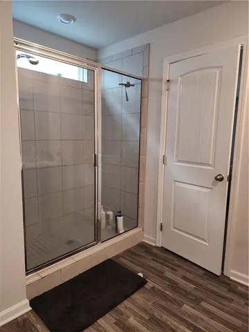 a bathroom with a glass shower door