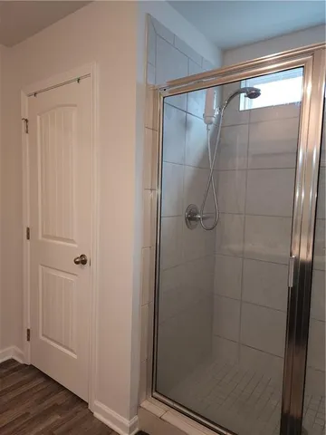 a bathroom with a glass shower door