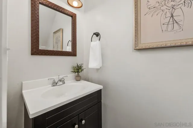 a bathroom with a sink vanity and a mirror