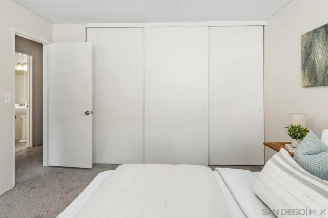 a bedroom with a bed and a plant