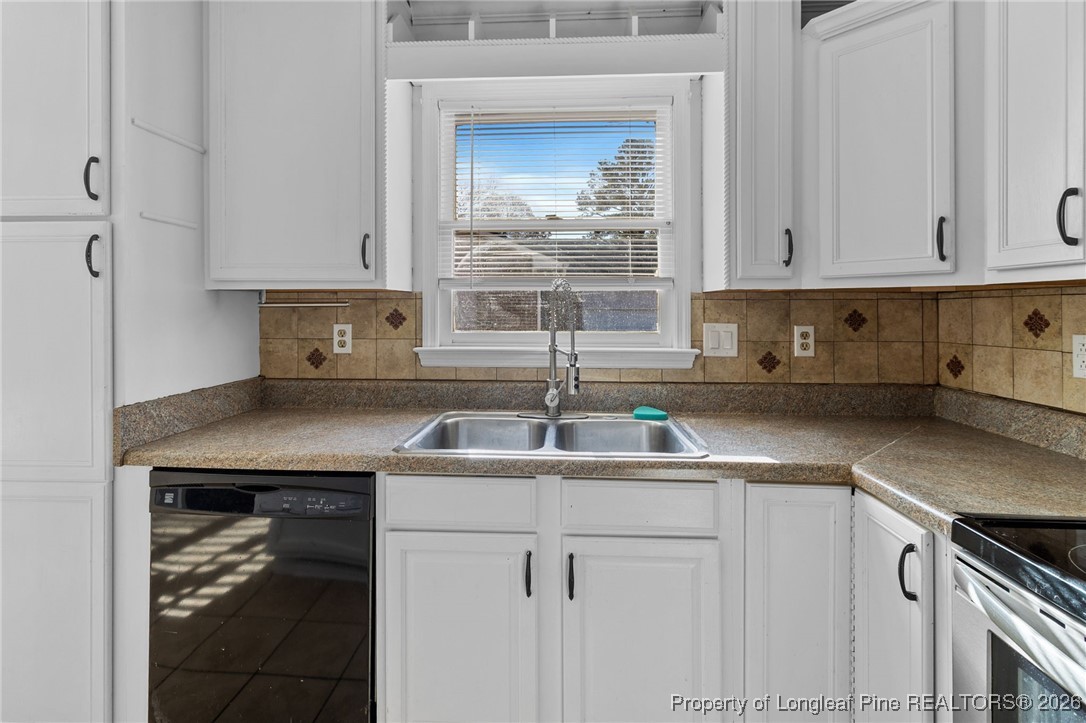 921 Flintwood Road Fayetteville, NC 28314 - Photo 16 of 44 a kitchen with a sink cabinets and window