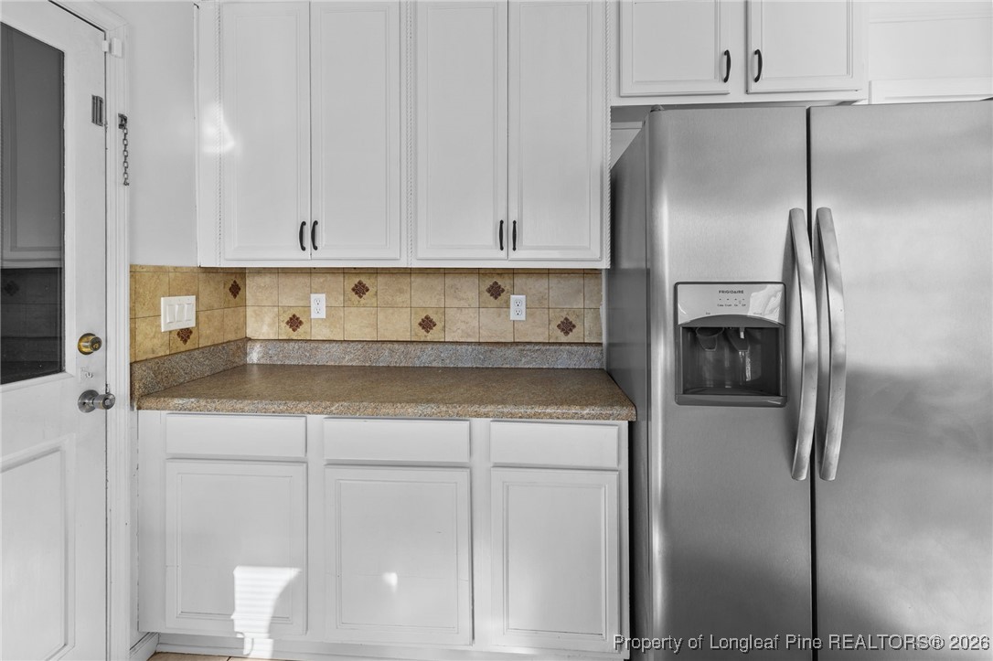 921 Flintwood Road Fayetteville, NC 28314 - Photo 18 of 44 a kitchen with a refrigerator and cabinets