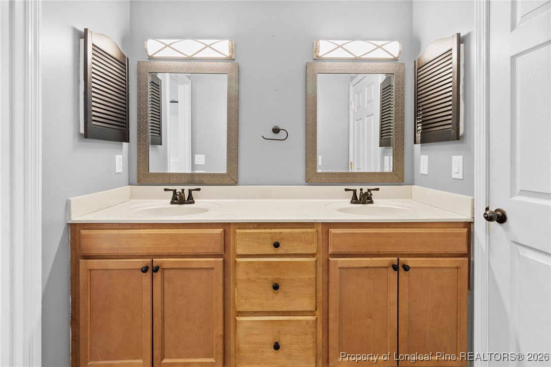 921 Flintwood Road Fayetteville, NC 28314 - Photo 30 of 44 a bathroom with a sink vanity and a mirror