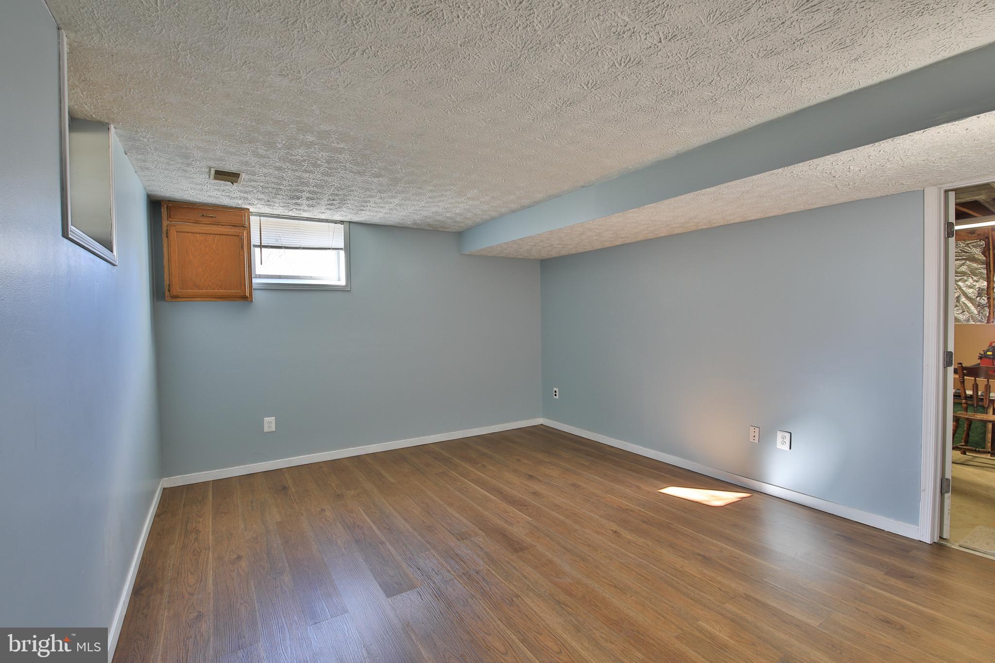 73 Hook Road Westminster, MD 21157 - Photo 22 of 32 Finished family room in basement, new flooring.