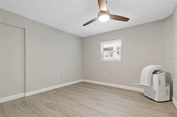 a room with window and hardwood floor