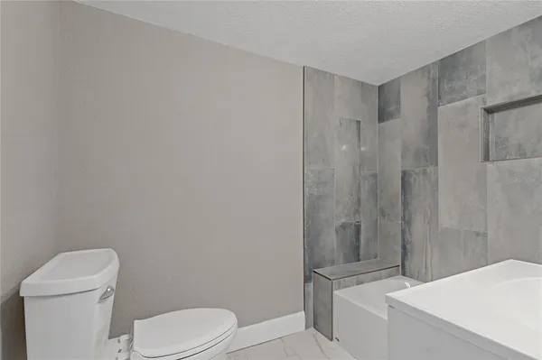 a white toilet sitting next to a bathroom sink