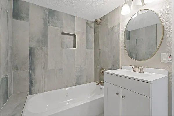a bathroom with a sink a shower and a mirror