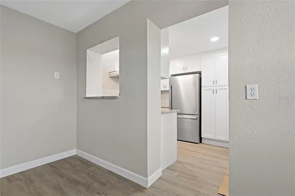 a view of a kitchen with a sink and a refrigerator
