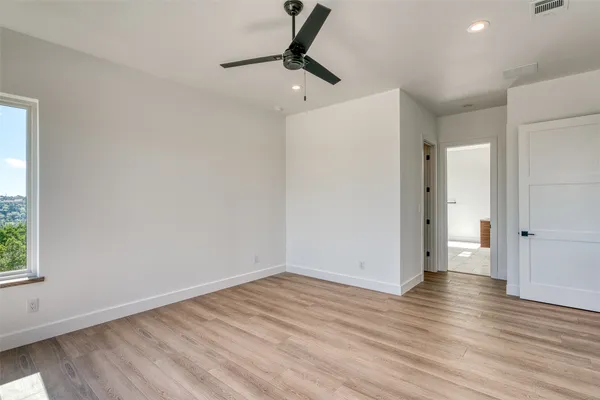 a view of an empty room with wooden floor