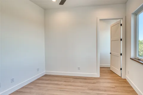 a view of a room with wooden floor