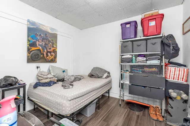a bedroom with furniture and wooden floor