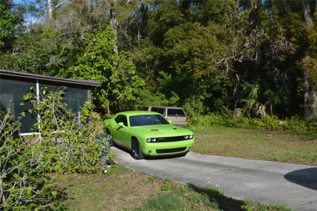 a view of a yard with wooden fence
