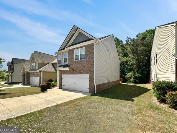 a front view of a house with a yard