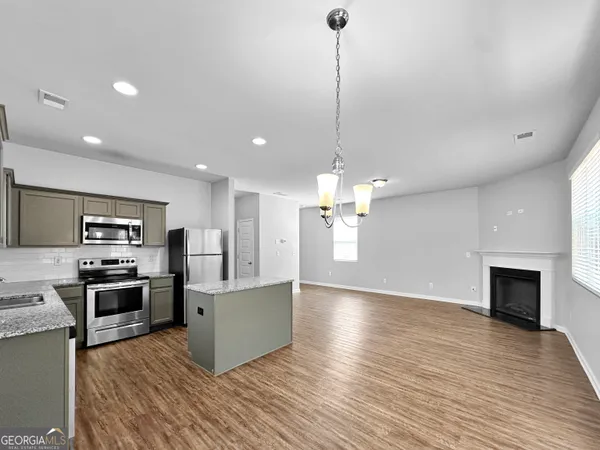 a view of a kitchen with a sink stainless steel appliances and cabinets