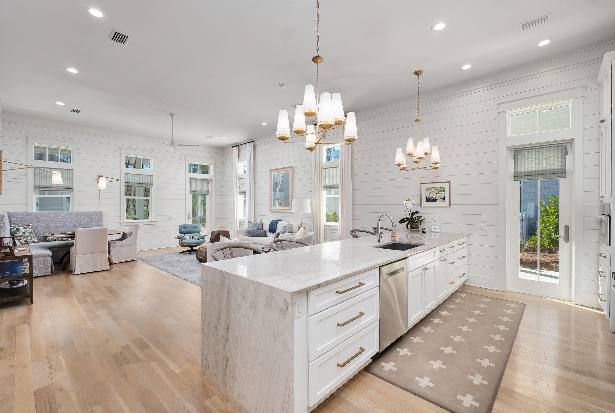 194 Sawbuck Dr Inlet Beach Inlet Beach, FL 32461 - Photo 3 of 38 a large white kitchen with a large island oven a sink dishwasher and white cabinets with wooden floor