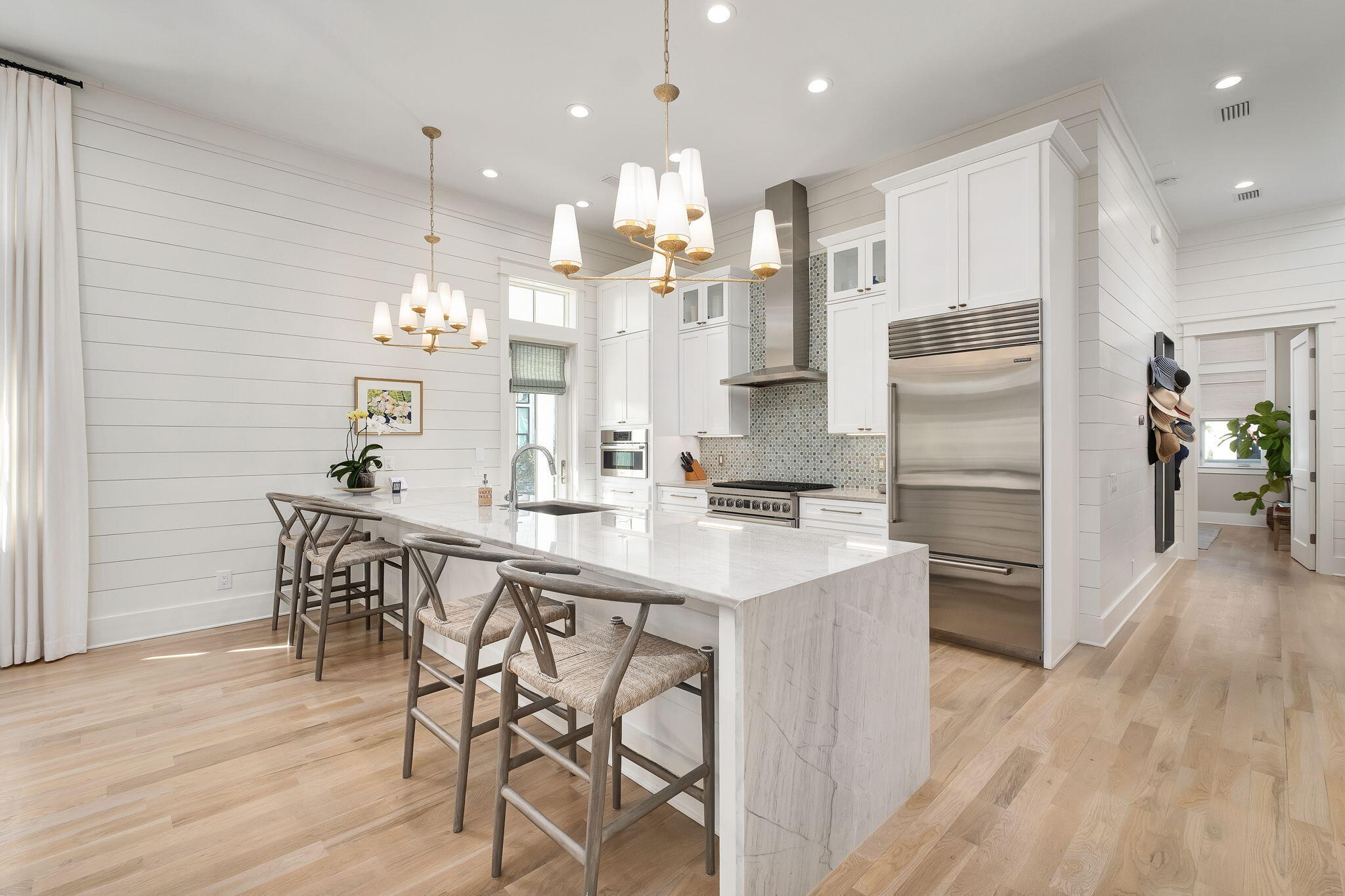 194 Sawbuck Dr Inlet Beach Inlet Beach, FL 32461 - Photo 6 of 38 a kitchen with kitchen island stainless steel appliances a dining table chairs and wooden floor