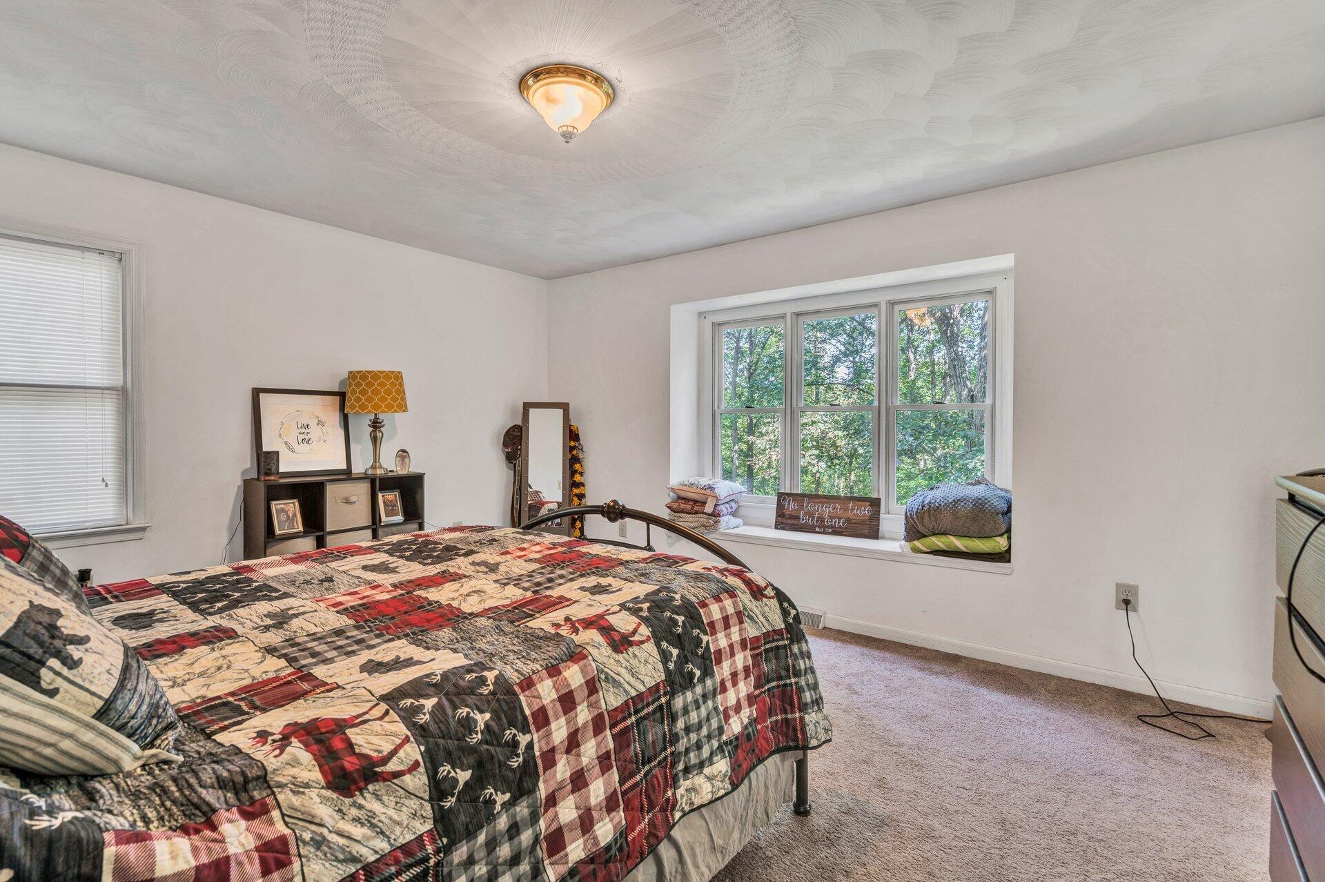 1842 Morris Road Goodview, VA 24095 - Photo 19 of 35 a bed sitting in a bedroom next to a window