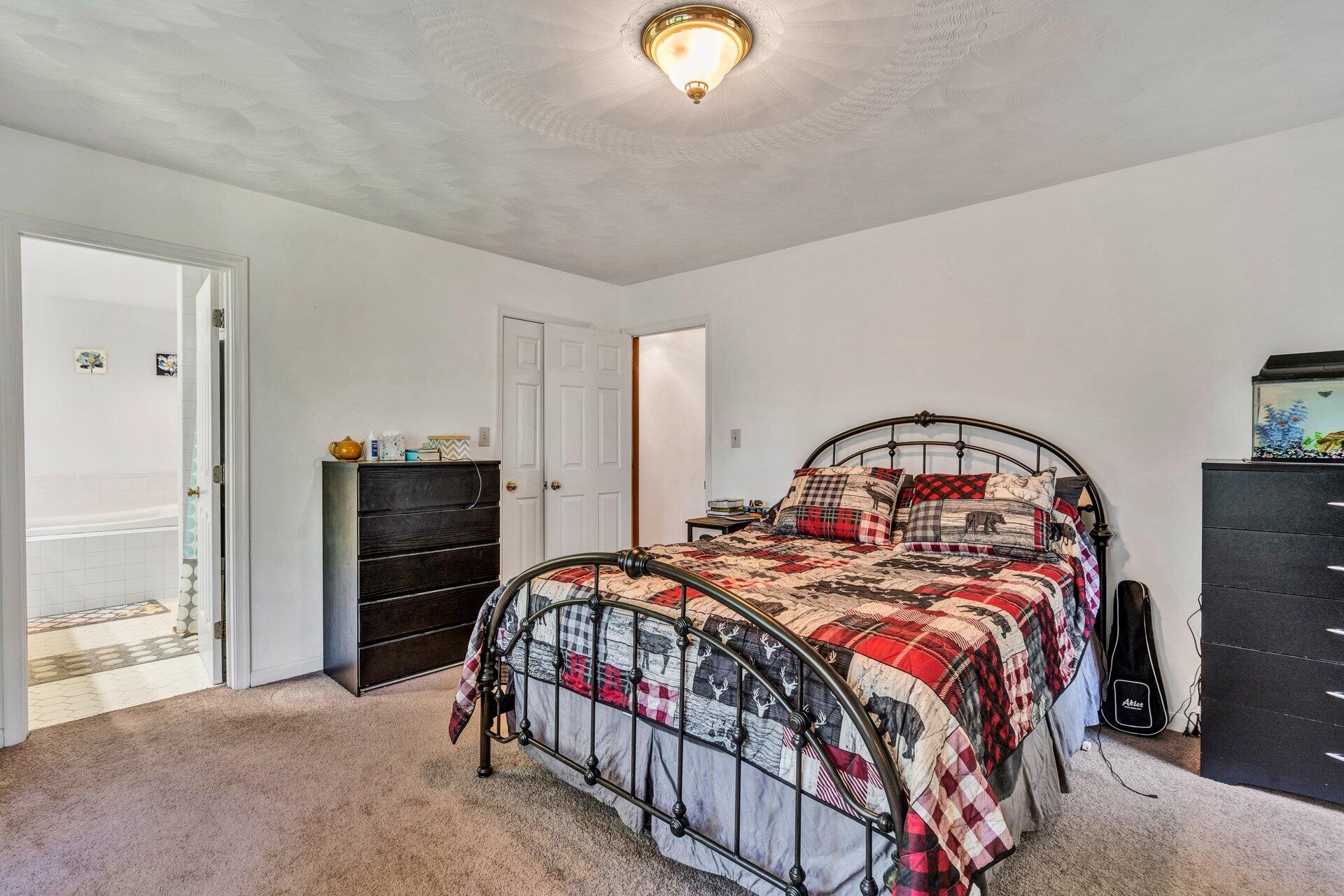 1842 Morris Road Goodview, VA 24095 - Photo 20 of 35 a bedroom with a bed and a chandelier