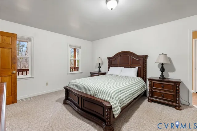 a bedroom with a bed lamp and a dresser