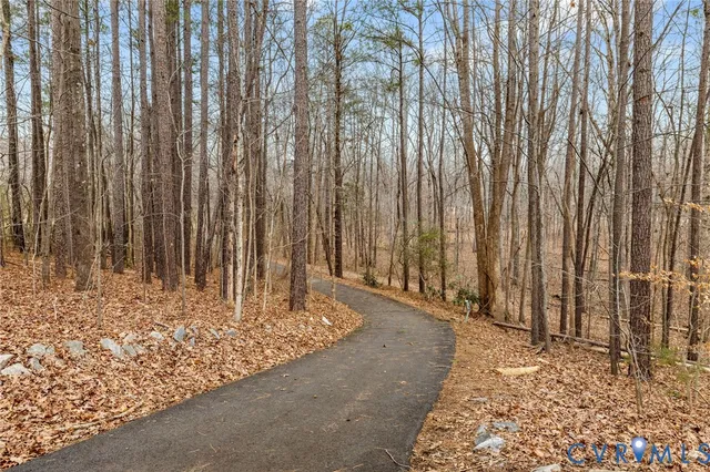 a view of a pathway with a wooden fence
