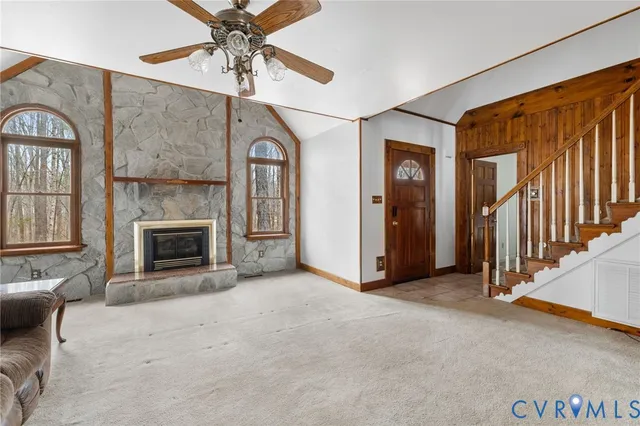 an empty room with windows and fireplace