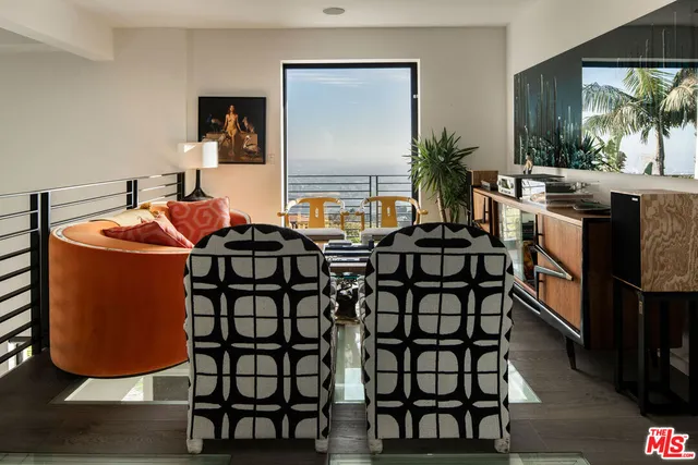 a dinning room with furniture and wooden floor