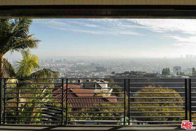 a view of a balcony with city view