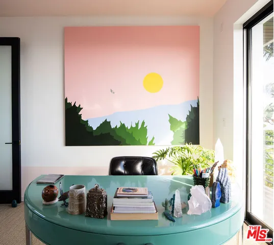 a view of a dining room with furniture and a potted plant
