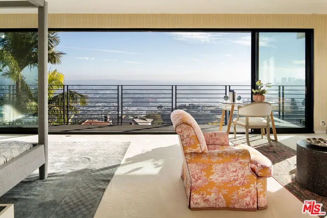 a bedroom with a large bed and a large window