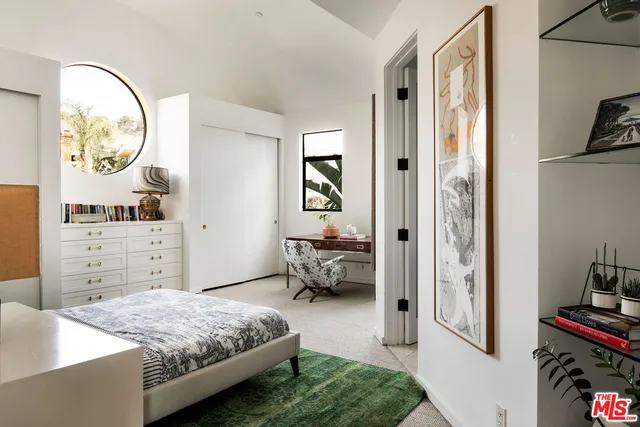 a bedroom with a bed and a cabinets