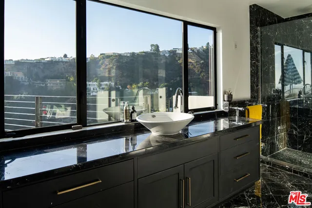 a living room with furniture and floor to ceiling windows