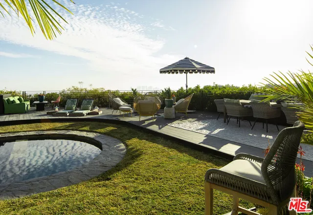 a view of a patio with lawn chairs
