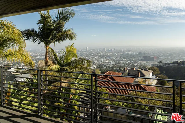 an aerial view of a house with swimming pool outdoor seating and yard