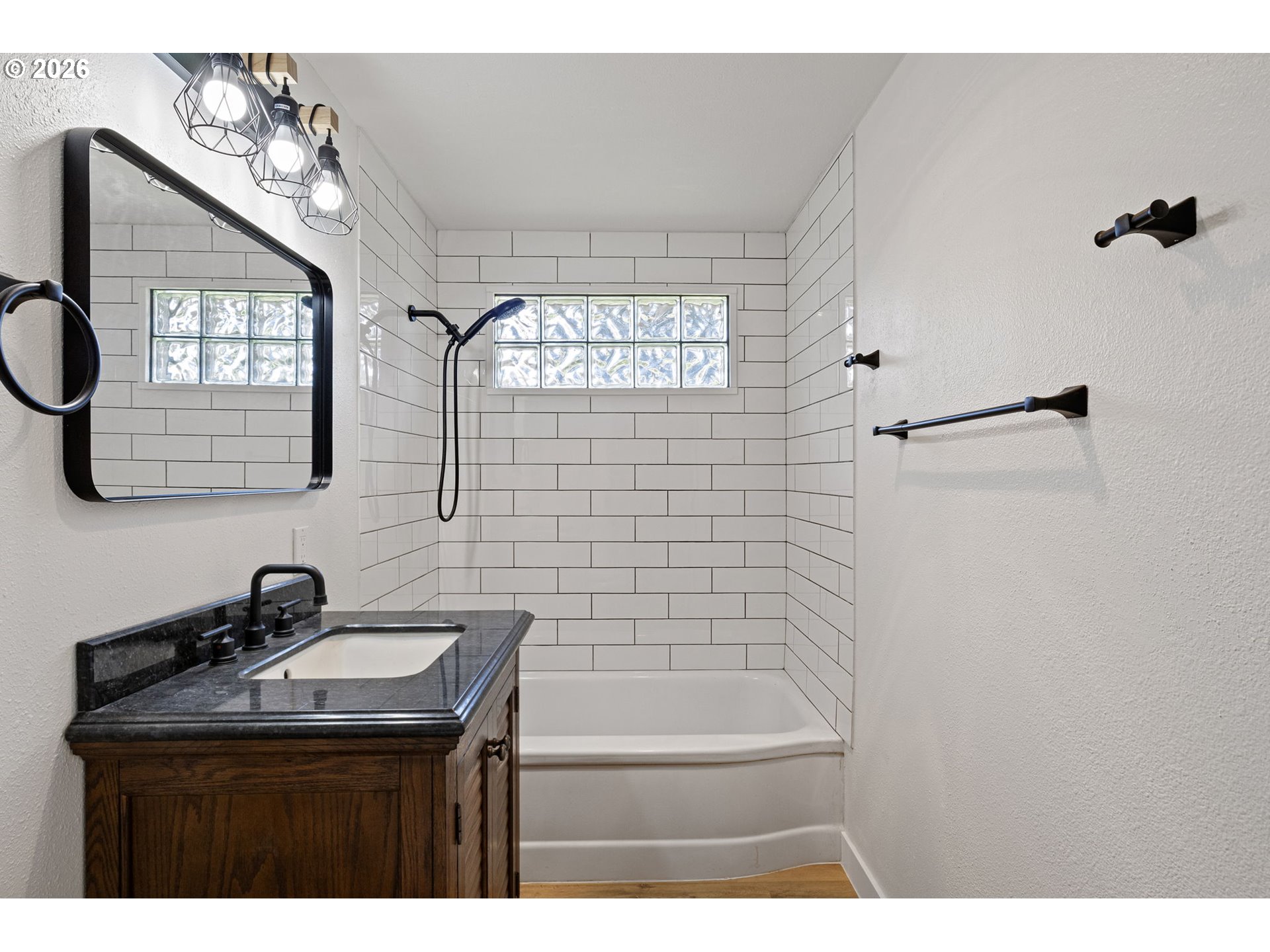 1008 Coburg Road Eugene, OR 97401 - Photo 39 of 46 a bathroom with a sink a mirror and a bathtub