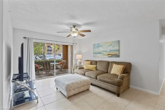 a living room with furniture and large windows