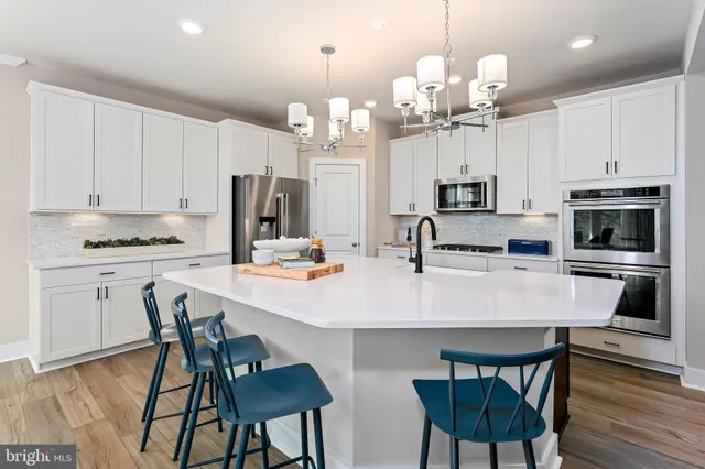 a kitchen with kitchen island granite countertop a table and chairs in it
