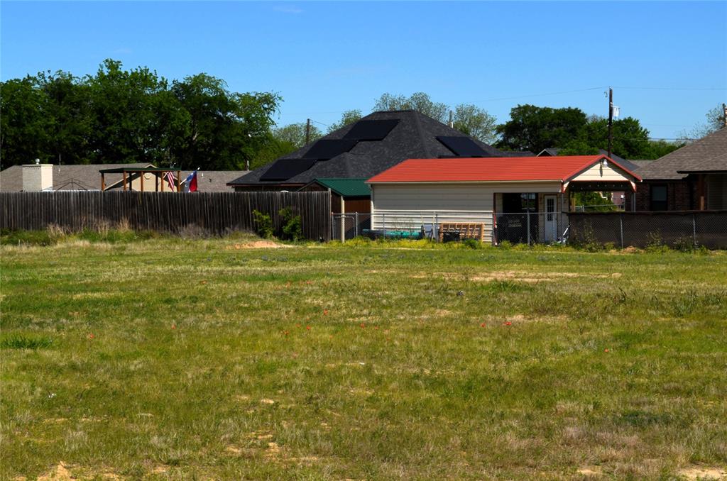 316 Preston Road Mabank, TX 75147 - Photo 5 of 5 a blue swimming pool is sitting in front of a house
