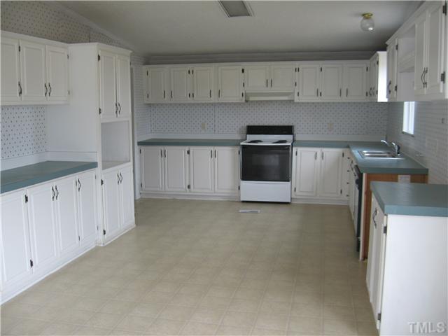727 Wake County Line Road Zebulon, NC 27597 - Photo 4 of 12 Huge kitchen with LOTS of cabinets, new flooring and french doors to deck.