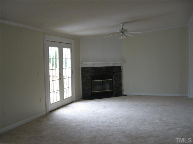 727 Wake County Line Road Zebulon, NC 27597 - Photo 6 of 12 Large living room with fireplace and french doors leading to deck