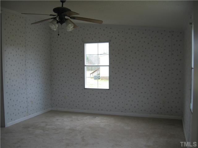 727 Wake County Line Road Zebulon, NC 27597 - Photo 9 of 12 Master has two walk in closets and french doors to bathroom.