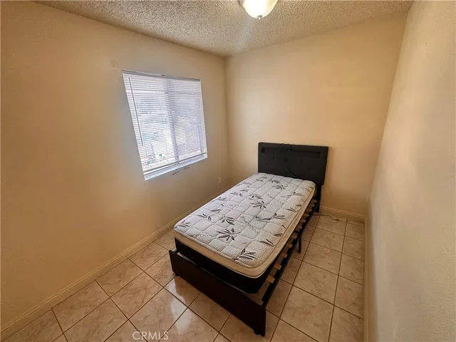 a view of a hallway with wooden floor and cabinet