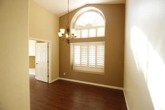 a large kitchen with kitchen island granite countertop a large window and stainless steel appliances
