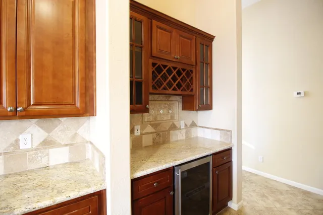 a kitchen with stainless steel appliances granite countertop a sink and a refrigerator
