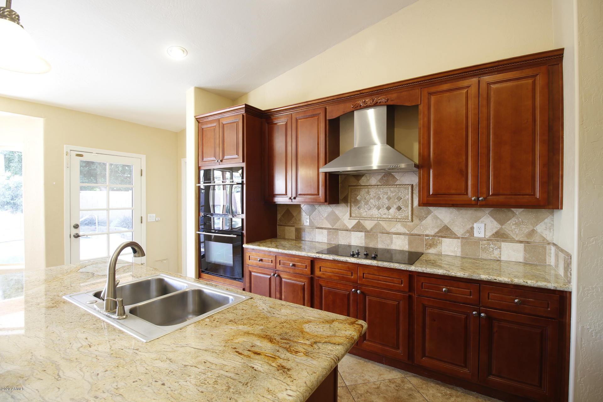1611 West Del Rio Street Chandler, AZ 85224 - Photo 20 of 38 a kitchen with granite countertop a sink stainless steel appliances and cabinets