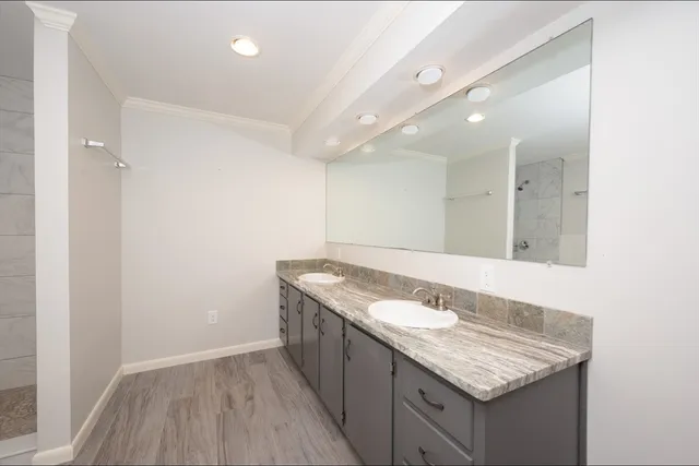 a bathroom with a granite countertop sink a toilet and a mirror