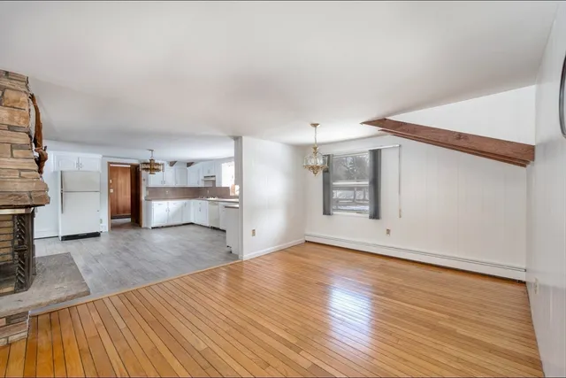a view of a kitchen with wooden floor and a kitchen