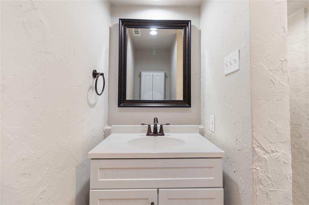9611 Baseline Drive Dallas, TX 75243 - Photo 11 of 21 a bathroom with a sink and mirror