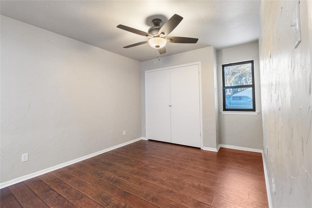 9611 Baseline Drive Dallas, TX 75243 - Photo 12 of 21 an empty room with wooden floor and ceiling fan