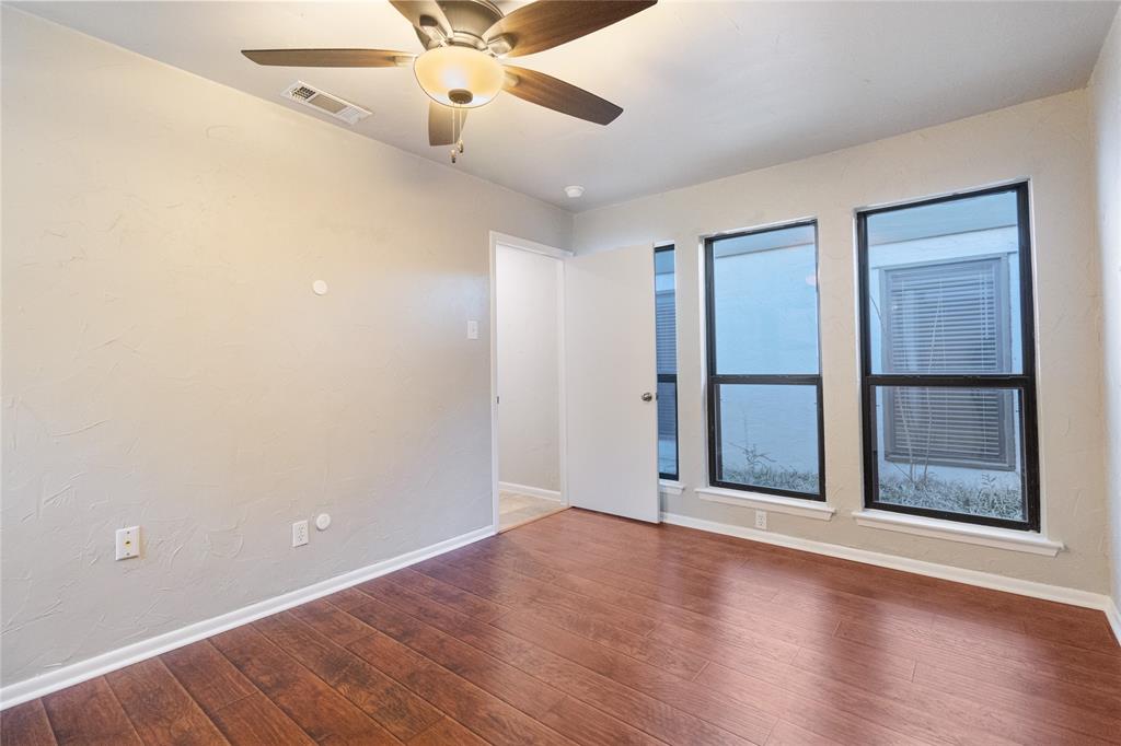 9611 Baseline Drive Dallas, TX 75243 - Photo 13 of 21 an empty room with wooden floor fan and windows