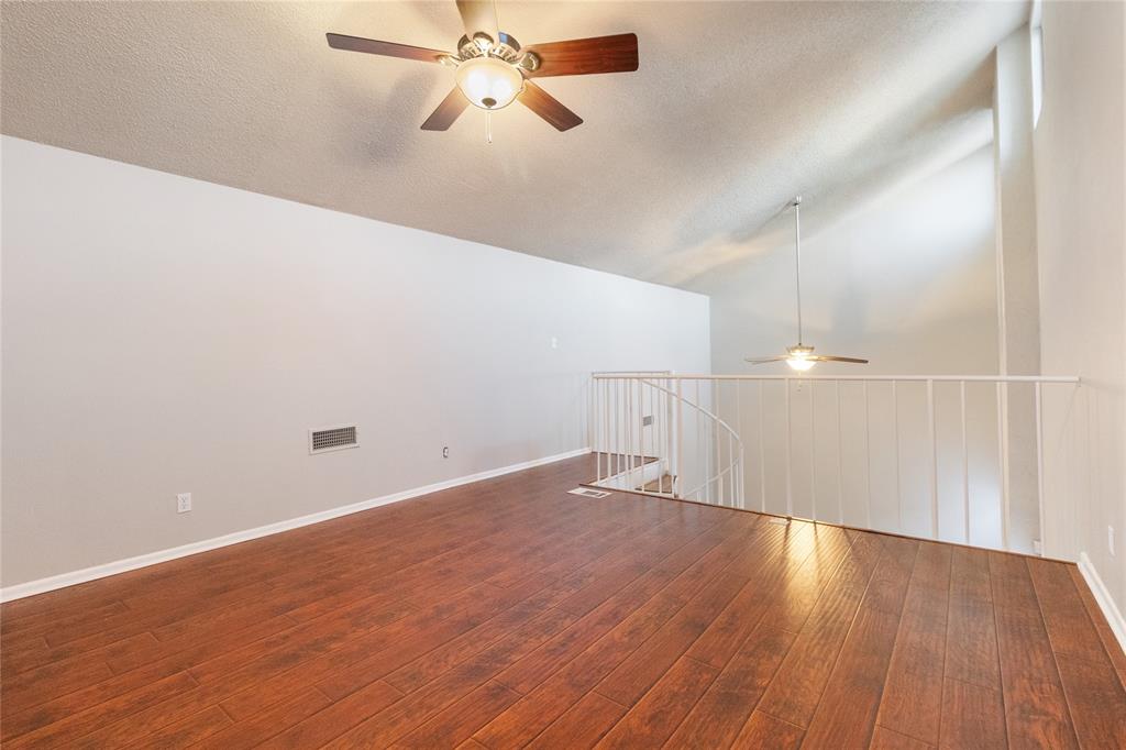 9611 Baseline Drive Dallas, TX 75243 - Photo 14 of 21 an empty room with wooden floor fan and windows